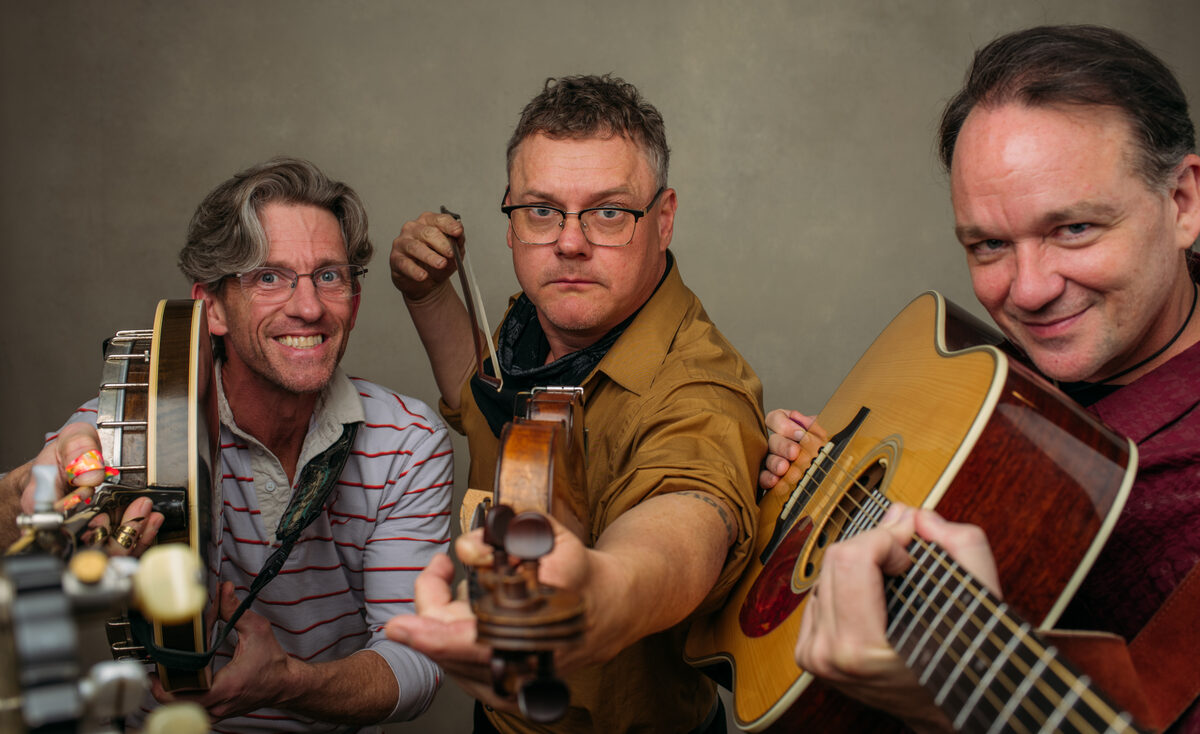 The band pointing their instruments